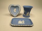 a blue and white bathroom set with a blue vase and a blue tray