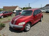 a red car parked in a parking lot with other cars