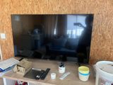une télévision à écran plat posée sur une table en bois