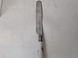 a knife that is laying on the floor next to a knife
