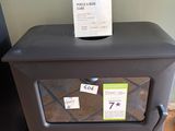 a small black stove with a sign on top of it