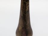 a small brown vase sitting on a white surface