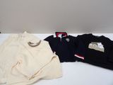 three pairs of men ' s clothing sitting on a table next to each other