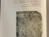 an open book with a black and white image of a piece of paper