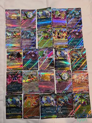 a pile of pokemon cards sitting on top of a table