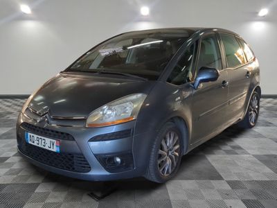 a picture of a small grey car parked in a garage