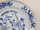 a blue and white plate with blue flowers on it