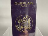 guerlain paris perfume in a clear box on a clear surface