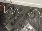 a power strip with a bunch of wires on the floor