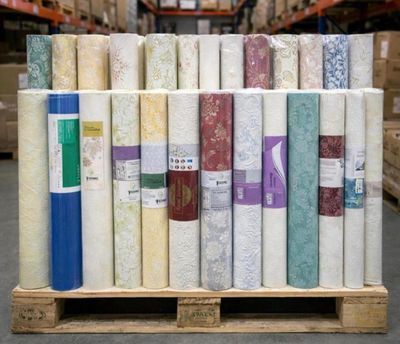 many rolls of fabric on a pallet in a warehouse