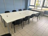 a table and chairs in a room with a large window