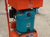 une machine orange et bleue posée sur un sol en béton