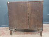 an old wooden cabinet with two doors on it