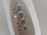 a close up of a remote control on a white surface