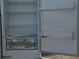 an open refrigerator sitting on a pallet in the dirt