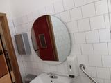 a bathroom with a sink, mirror, and toilet in it