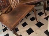 a chair and a table in a room with black and white checkered flooring