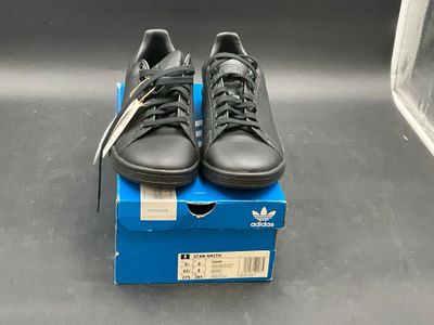 a pair of black shoes on top of a blue box