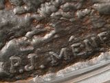 a close up of a piece of metal with writing on it