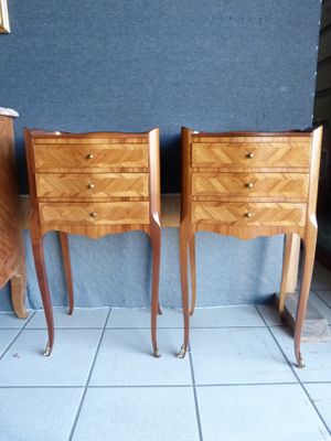 two nightstands that are next to each other on a tiled floor
