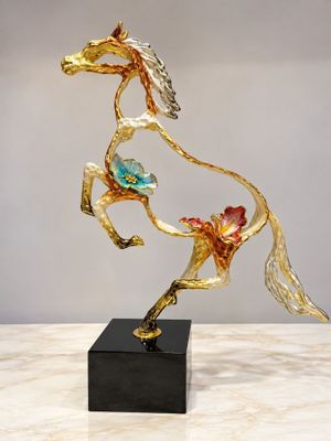 sculpture of a horse running with flowers on its back on a marble base