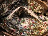 a purse that has a floral pattern inside of it