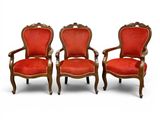 two red chairs sitting next to each other on a white surface