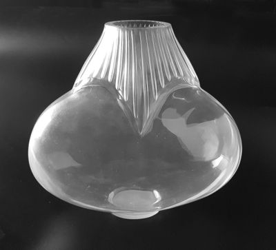 black and white photograph of a glass vase with a heart in it