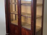 an image of a wooden display cabinet with glass doors