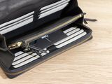 a black purse with a bunch of cards inside of it