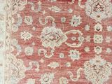 a red and beige rug with a floral design on it