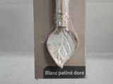 a silver spoon that is in a box on a table