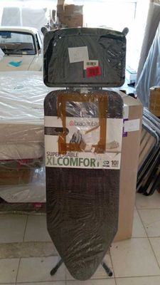 a stack of luggage sitting on top of a bed in a room