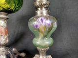 two vases with flowers painted on them sitting next to each other