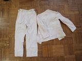 a pair of white pants and a white jacket on the floor