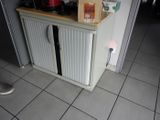 a small cabinet with a door on the side of it