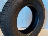 a close up of a tire on a white surface next to a wall