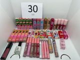 a lot of lipsticks and lip bales on the table