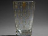 a glass that has a gold design on it