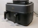 a large black machine sitting on top of a white table