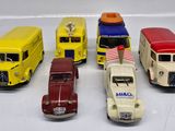 five toy cars that are lined up on a white surface
