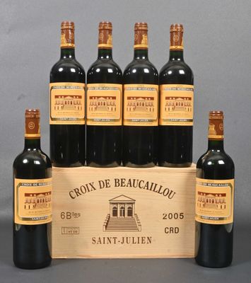 six bottles of red wine in a wooden crate on a table