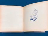 an open book with a drawing of a sailboat on it