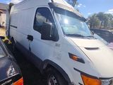 a white van that is parked next to a black car