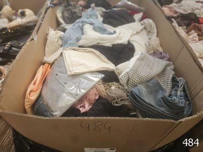 a cardboard box full of clothes on a table