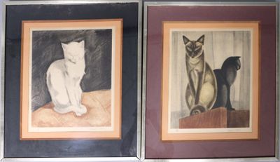 two framed pictures of cats sitting on a table