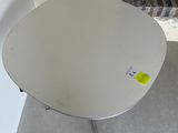 a small white table with a yellow sticker on it