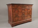 an old wooden chest of drawers with marble top