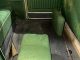 a green seat in the back of a green car