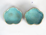 pair of blue ceramic bowls with gold rims on a white surface